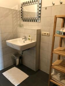 a bathroom with a sink and a mirror at Ferien- und Winzerhof Ute Braun in Nordheim