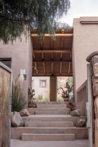 a set of stairs leading to a building with a wooden ceiling at Patio Alto in Tilcara