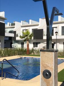 a swimming pool in front of a building at Modern Studio Lamar Resort in Pilar de la Horadada