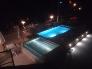 an overhead view of two swimming pools at night at Locanda San Marco in Torri del Benaco