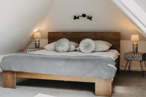 a bedroom with a bed with pillows on it at Apartament Rynek Pniewy in Pniewy
