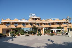 a large building with a plaza in front of it at Hotel Medusa in Lampedusa