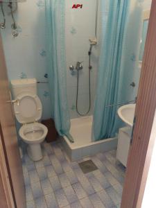 a bathroom with a toilet and a shower and a sink at Apartments Šudić in Njivice +34 photos