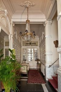 a large room with a chandelier and a hallway at B&B The Baron in Antwerp