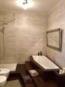 a bathroom with a tub and a toilet and a sink at SEA TOWERS PENTHOUSE 23-24 Two-Floors Sea View Panoramic Terrace 110m2 !!! jacuzzi in Gdynia