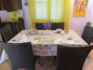 a dining room table with chairs and a table cloth at Gatto Matto in Manziana