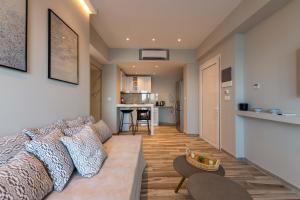 a living room with a couch and a kitchen at Valtes Luxurious Apartments in Mpoukaris
