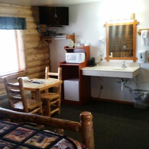 Kuchyň nebo kuchyňský kout v ubytování Wolf Den Log Cabin Motel and RV Park