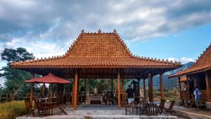 a pavilion with tables and chairs and a roof at ParLezo in Lengkoajang