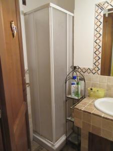 a shower stall in a bathroom next to a sink at Gatto Matto in Manziana +8 photos
