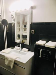 a bathroom with a white sink and a mirror at Superbe appartement contemporain in Le Touquet-Paris-Plage +15 photos