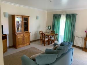 a living room with a blue couch and a table at Santa Barbara Healthcare & Villas in Santa Barbara