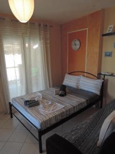 uma cama num quarto com um relógio na parede em Konba luxury mini apartment em Tessalônica