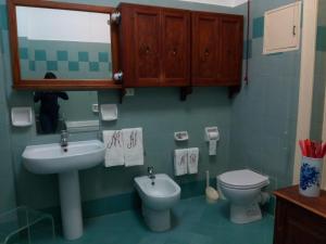 a bathroom with a sink and a toilet and a mirror at Fieschi Inn in Genoa +17 photos