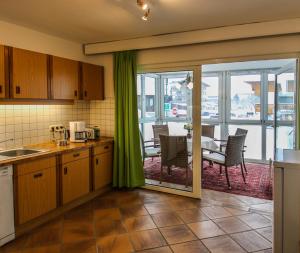 a kitchen with a view of a dining room at Appartements Sam in Lermoos