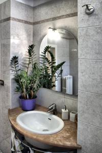 a bathroom with a sink with a mirror and plants at B&B Le Terrazze Fermo in Fermo