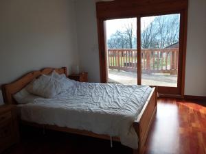 a bedroom with a bed and a sliding glass door at Heavens Gate in Saint-Pierre-de-Soucy