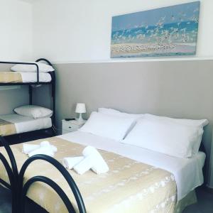 Postel nebo postele na pokoji v ubytování Cimalù by Lampara