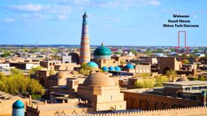 a view of a city with a mosque and a minaret at Khiva Tosh Darvoza in Khiva