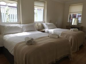 two beds with towels on them in a bedroom at Ard Cashel, Barrack Brae in Dungloe