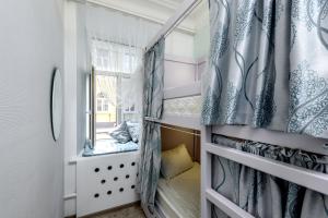 a small room with a bed and a window at Хостелы Рус - на Пречистенке in Moscow