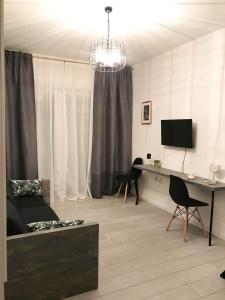 a living room with a couch and a desk at stuDio 57 II in Alexandroupoli
