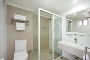 a bathroom with a shower and a toilet and a sink at Best Western Casula Motor Inn in Liverpool