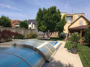 a swimming pool in the yard of a house at Garden & Pool apartment in Trnava