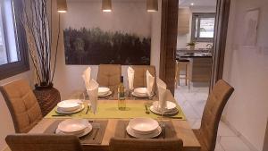 a dining room table with chairs and a dining room at Menies Mediterranean Heights in Parekklisha