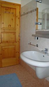 a bathroom with a white sink and a mirror at Appartement Les Clarines in Les Houches