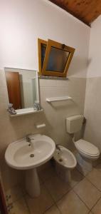 a bathroom with a sink and a toilet at Bungalow Coronas in Bonorva