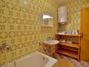 a bathroom with a bath tub and a sink at Dada Apartments in Lopar