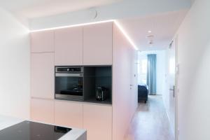 a white kitchen with white cabinets and a stove at Vienna Residence, Hietzing - Schönbrunn in Vienna