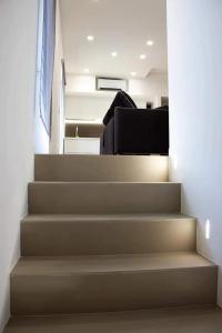 a staircase in a house with a black chair at Xenia, B&B Soverato in Soverato Marina