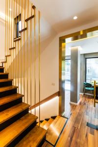 a staircase in a house with wooden floors and a table at La Suite Boutique Hotel in Tirana