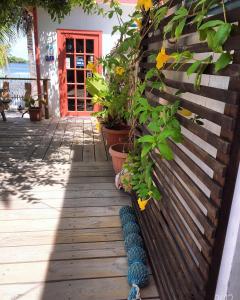 a small wooden bench next to a house at Ambergris Sunset Hotel in San Pedro