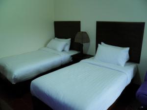 Postel nebo postele na pokoji v ubytování Ruen Narisra Resort