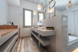 a bathroom with a sink and a mirror at Osom Resort in Ornos