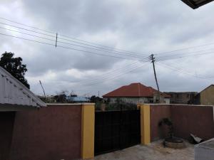 a fence in front of a house with at TJ Cottage in Ilorin