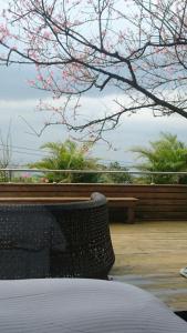 a bedroom with a bed and a tree with pink flowers at Listening to the wind B&B in Jiufen +37 photos