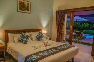 Кровать или кровати в номере Cozy Cottages Lombok