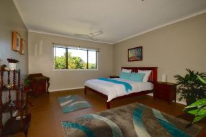 1 dormitorio con cama y ventana en A Daintree Garden, en Diwan