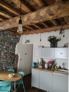 a kitchen with white cabinets and a wooden table at La casa di Gigioz in Sestri Levante