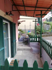 a porch of a house with a fence and a table at La casa di Gigioz in Sestri Levante