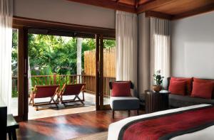 a hotel room with two beds and two chairs at Anantara Rasananda Koh Phangan Villas in Thong Nai Pan Noi