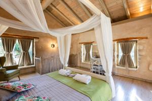 A bed or beds in a room at Vrisali Traditional Stone Villa