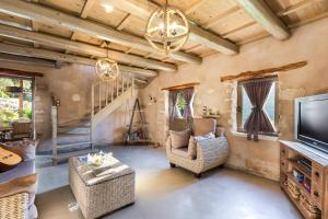 A television and/or entertainment centre at Vrisali Traditional Stone Villa