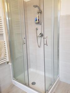a shower with a glass shower stall in a bathroom at B&B Buscemi in Pistoia +38 photos