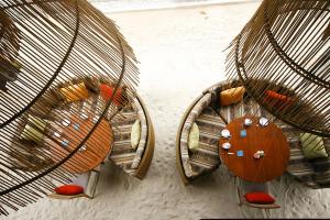a group of wooden chairs in a room with aagame at Anantara Rasananda Koh Phangan Villas in Thong Nai Pan Noi
