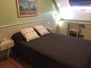 A bed or beds in a room at ATICO PINTOR ERNESTO GODAY
